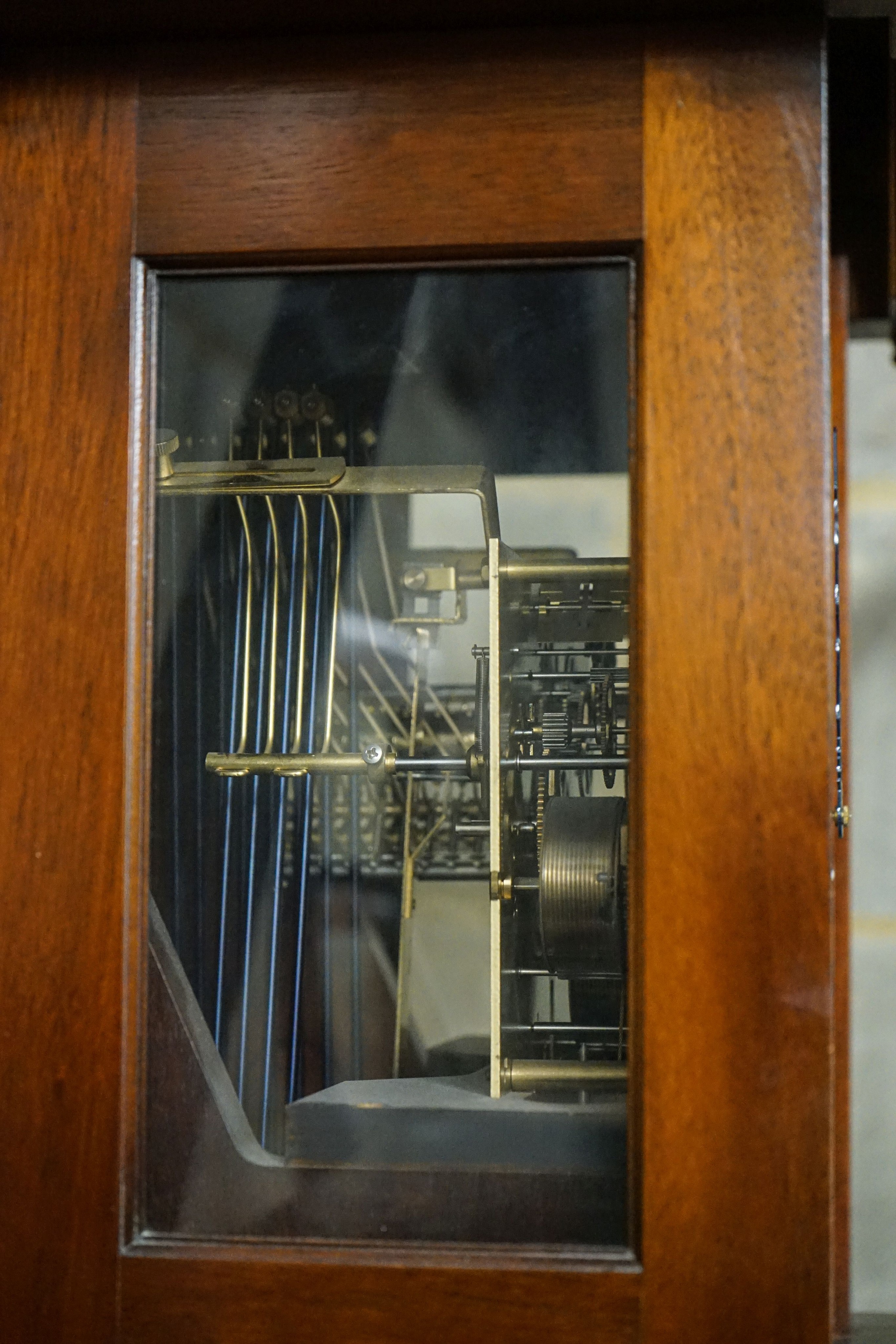 A modern mahogany longcase clock by Comitti London eight day, striking and chiming movement, brass dial with rocking ship automaton, the case with bulls-eye door, height 203cm